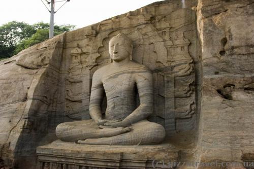 The seated image, which depicts the dhyana mudra, shows signs of Mahayana influence.