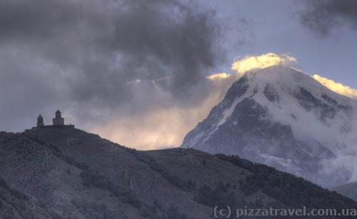 View of Trinity Church in Gergeti and Mount Kazbek