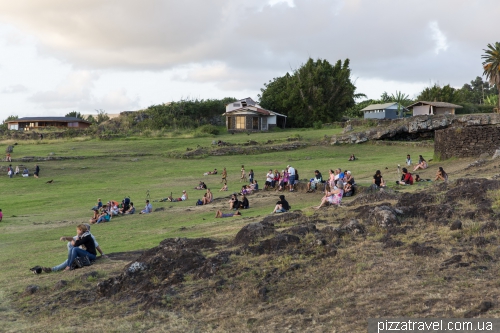 Tourists wait for the sunset near Ahu Tahai