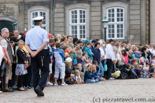 Tourists wait for the Changing of the Guard ceremony near the Royal Palace.